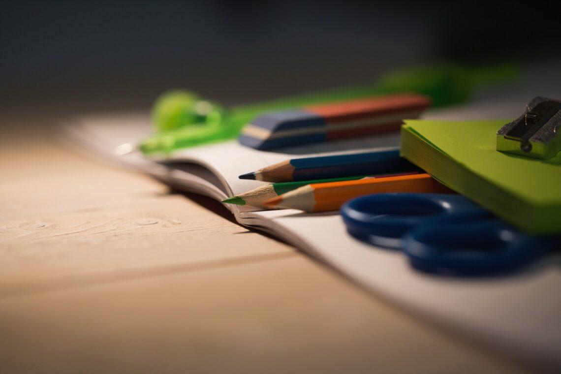 Students table with school supplies on it
