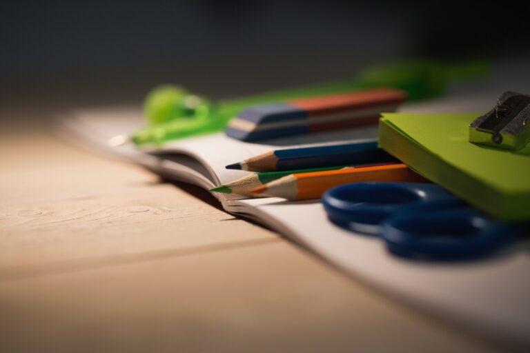 Students table with school supplies on it